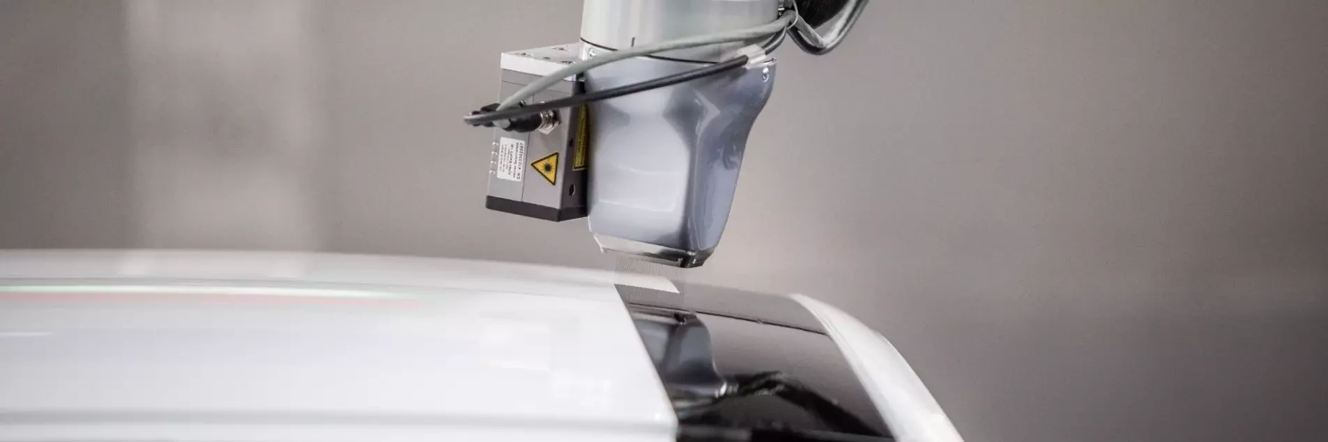 View of EcoPaintjet spraying the surface of a car body