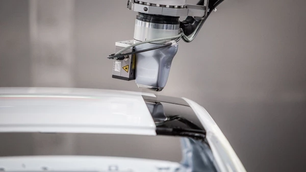 View of EcoPaintjet spraying the surface of a car body