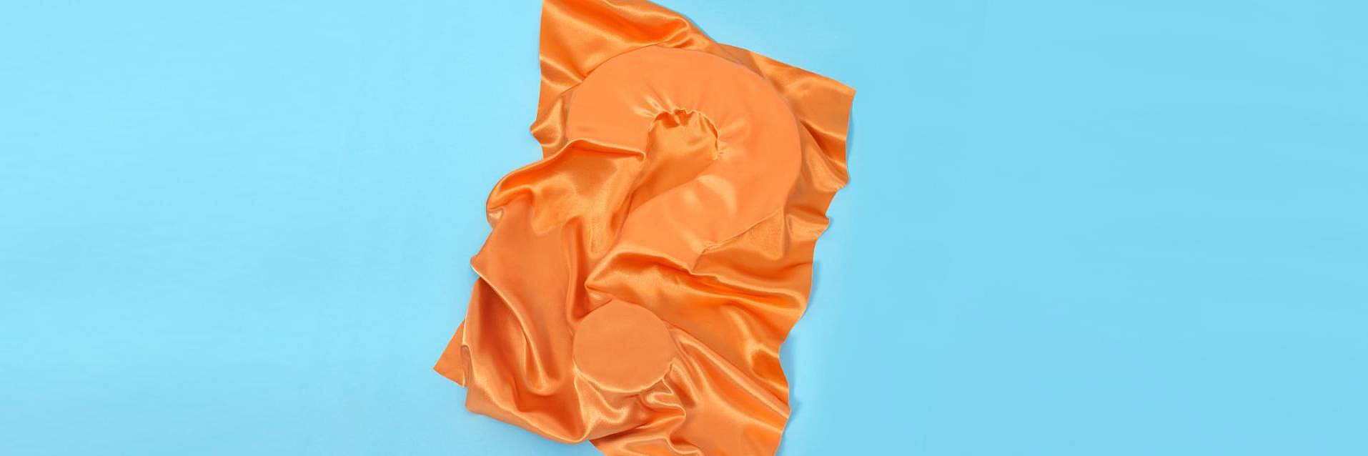 ECO cover picture of a questionmark covered by orange textile