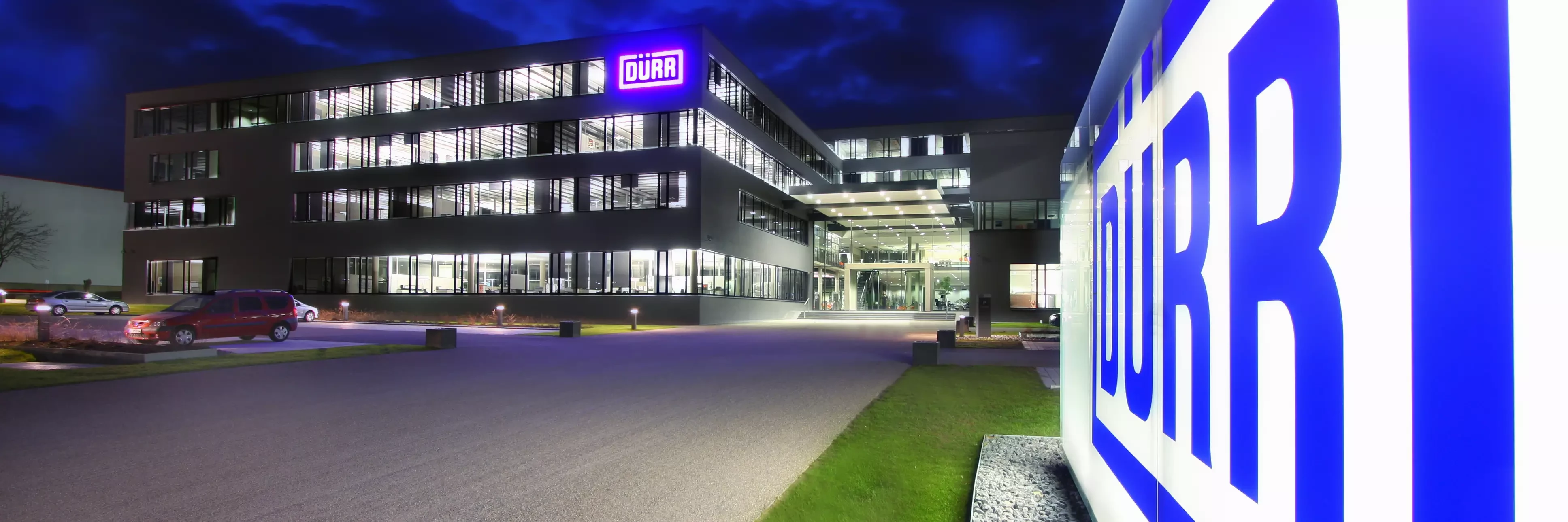 duerr location headquarters in germany at night viewing the shining logo in the front of the building