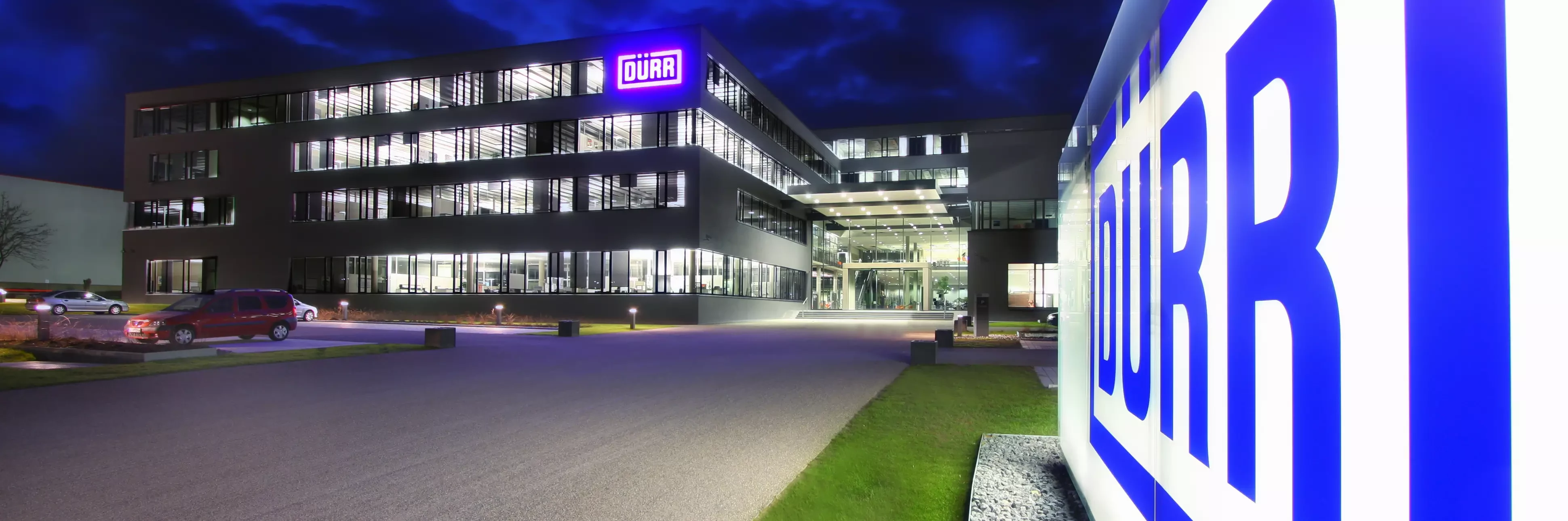 duerr location headquarters in germany at night viewing the shining logo in the front of the building