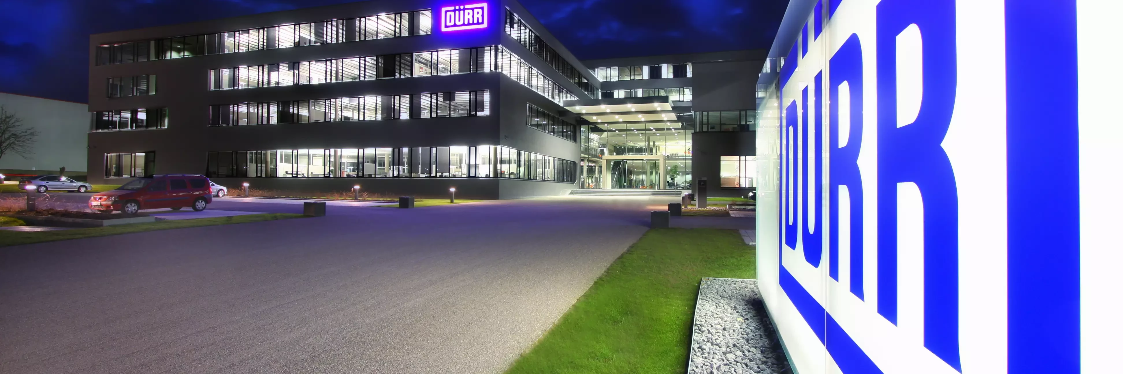 duerr location headquarters in germany at night viewing the shining logo in the front of the building